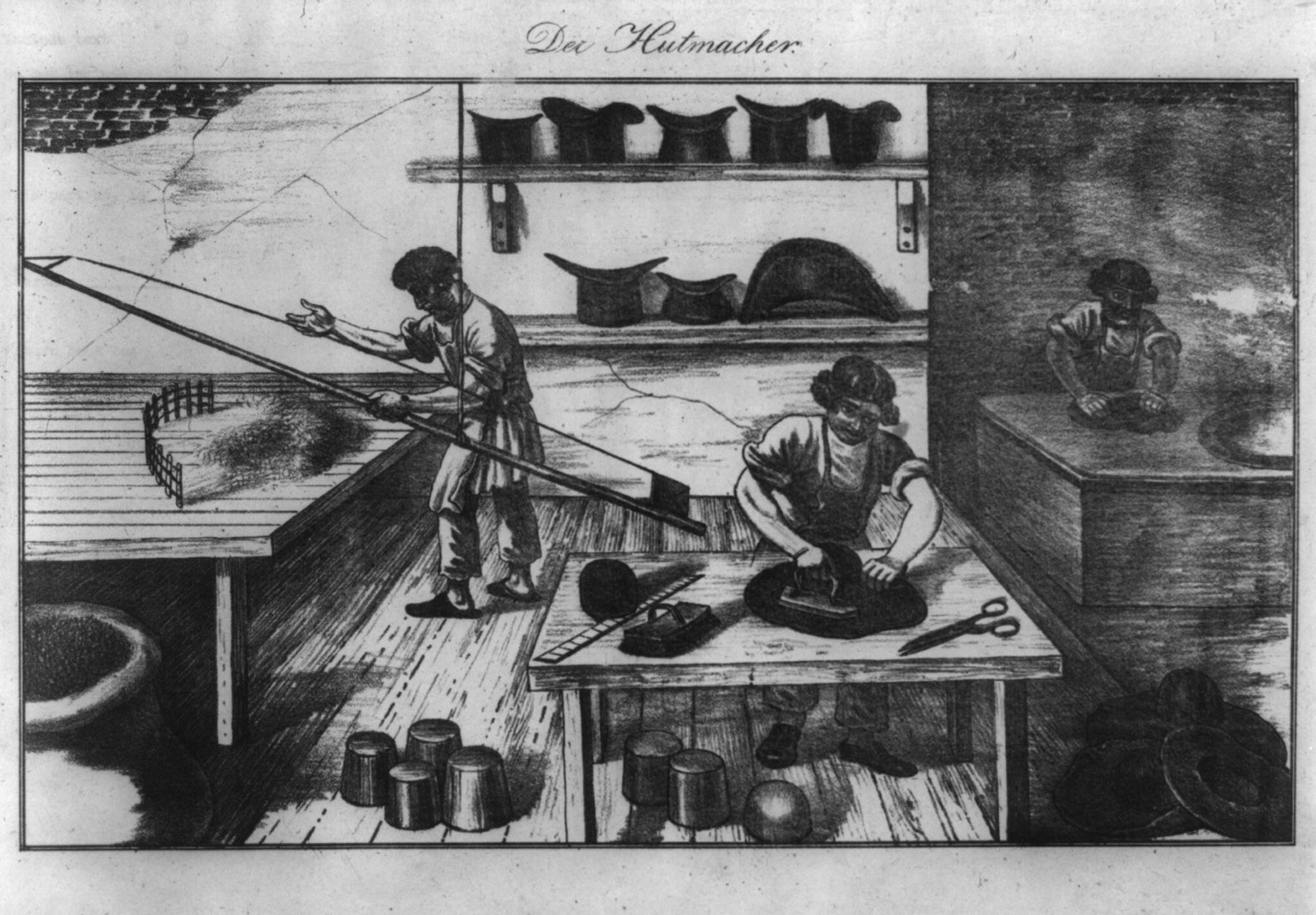 Lithograph titled Der Hutmacher: one man bows fur on a table with a long bow, another irons a felt hat, a third works at a kettle, finished hats on shelves