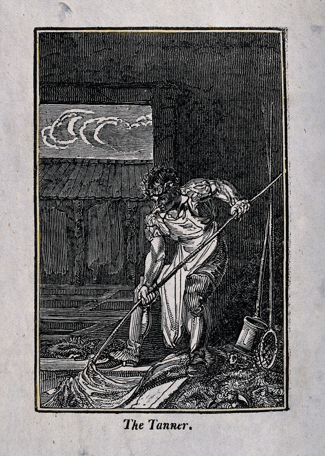 Wood engraving of a man in an apron leaning on a long pole to move a hide in a pit, with hides hanging in the shed behind him